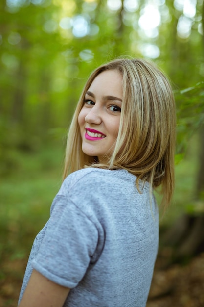 Vertical Shot of a Caucasian Woman Posing in the Woods of Bosnia and Herzegovina