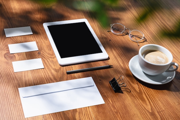 Gadgets, Coffee, and Work Tools on Wooden Table Indoors