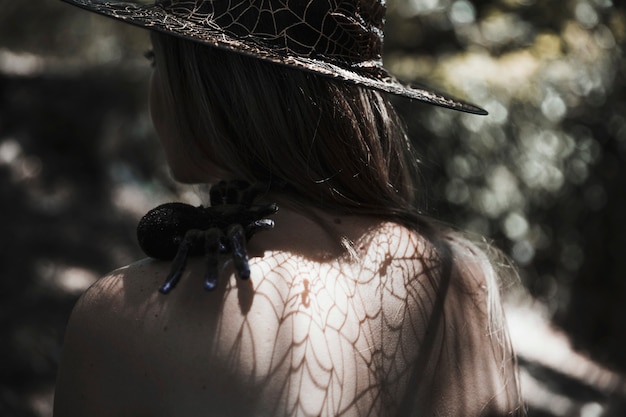 Young Woman with Tarantula on Shoulder in Forest – Free Download