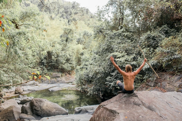 Tourist Sitting on a Stone in the Forest – Sumbawa