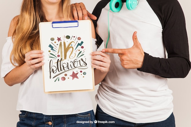 PSD Templates: Couple Holding Clipboard – Free Download