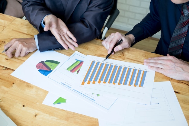 Business Team Discussion in Office: Collaborating and Analyzing Charts