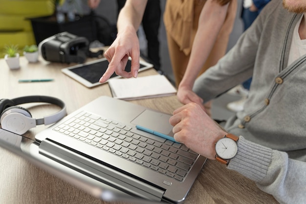 High Angle Shot of a Man and Woman Working with a Laptop and Headphones