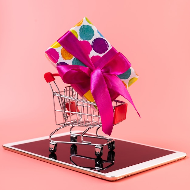 Shopping Cart with Gift on Top of Tablet