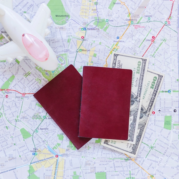 Elevated View of Airplane, Passport, Banknotes, and Map