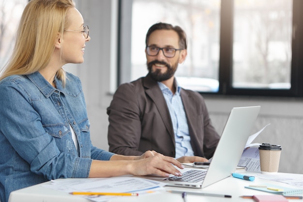 Portrait of female manager and her boss working together in office