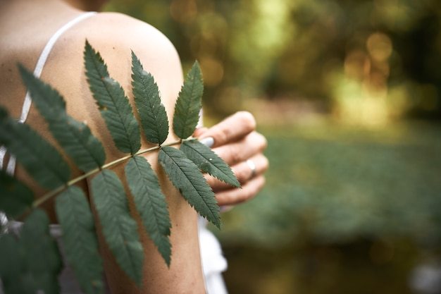 Cropped Image of Mysterious Young Woman Posing in Park with Green Leaf – Free Download