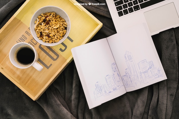 Book composition with coffee, cereals and laptop