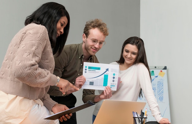 Group of young people teaming up at work