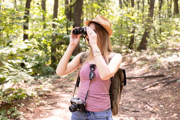 Woman in the woods with binoculars