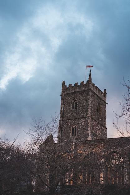 Vertical shot of St Peter’s Church in Bristol, UK under a clouded sky