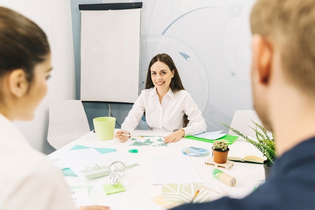 Happy female manager sitting in office – Free Stock Photo