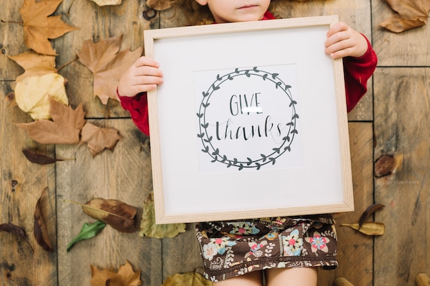 Thanksgiving concept with girl holding frame