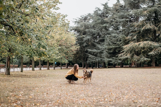 Pretty young woman petting her dog