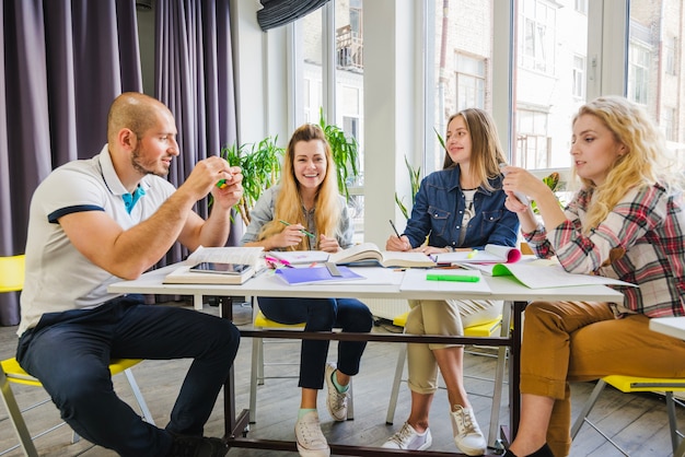 Group of people at table with books