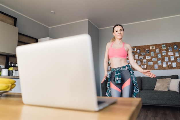 Woman Dancing at Home After Watching Video Lessons on Laptop