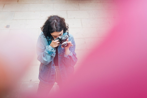 High angle view of woman taking photo with camera