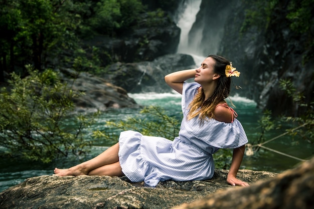 Girl Sitting by the Waterfall – Free Download