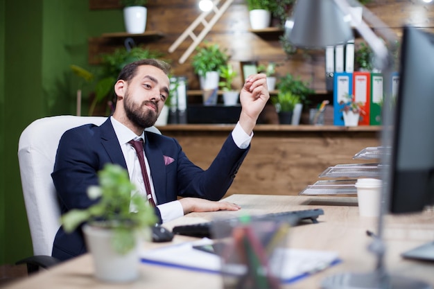 Handsome Bearded Businessman Proudly Looking at Computer Monitor