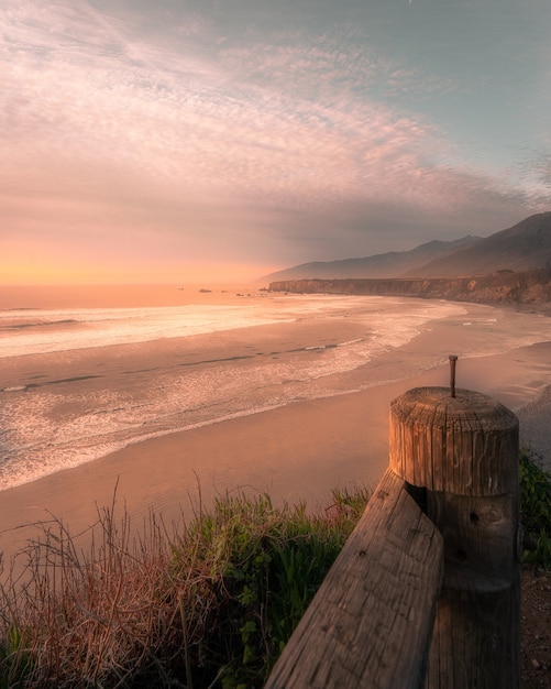 Vertical shot of the beach during a sunset – Free Stock Photo Download