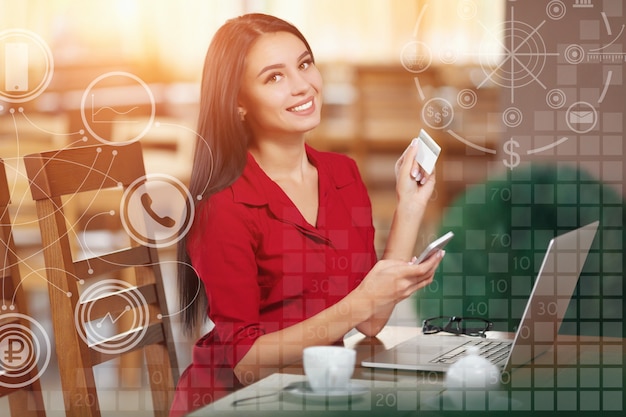 Smiling woman with a card and a mobile