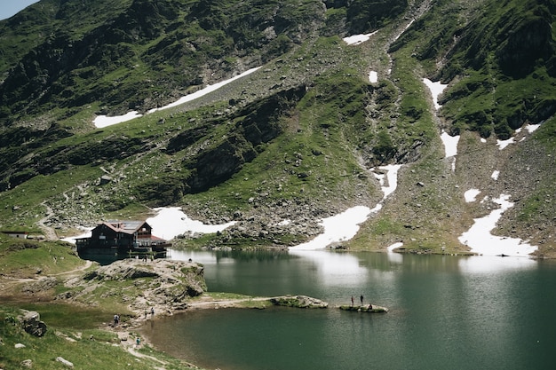 Landscape View of Balea Lake in Romania and Fagaras Mountains in the Summer with Snowy Peaks