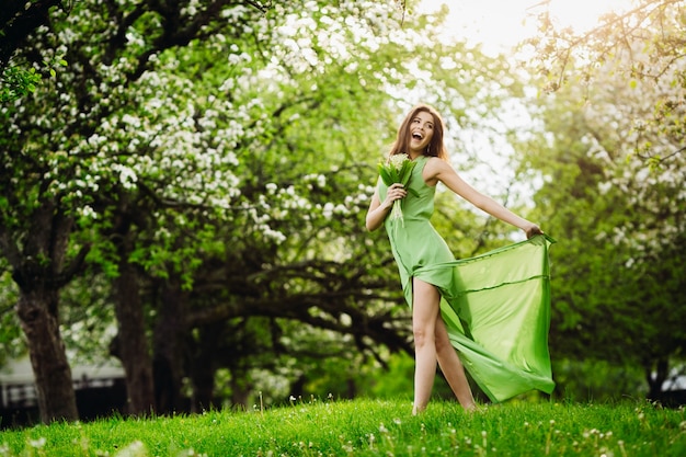 Cheerful Lady Jumping in a Green Garden – Free Stock Photo for Download