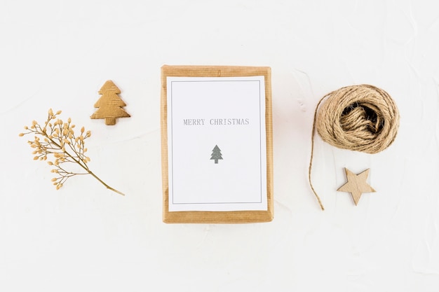 Tablet with paper between decorative fir tree, star and threads