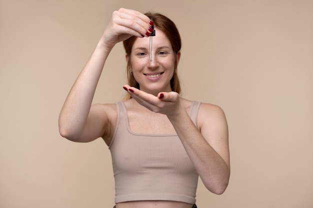 Young Woman Pouring Serum on Her Hand – Free Stock Photo for Download