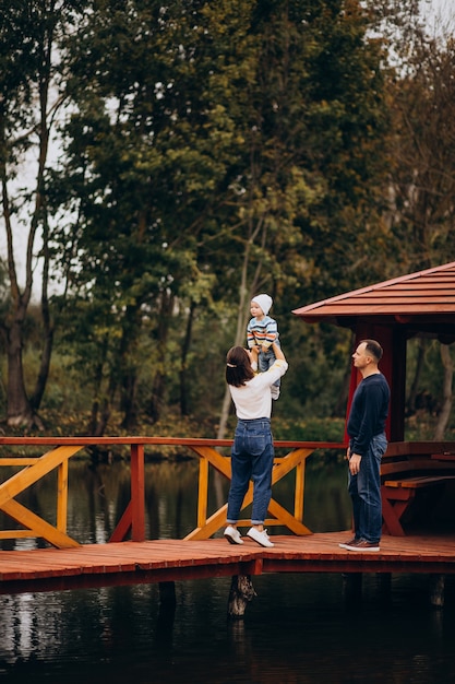 Young Family Walking on Bridge by River – Free Stock Photo Download