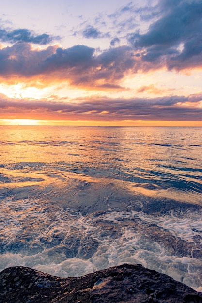 Breathtaking Scenery of a Rocky Beach on a Beautiful Sunset Background