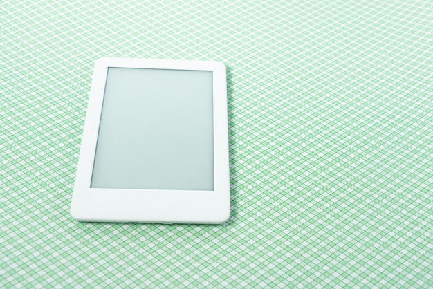 Ebook reader over green striped background