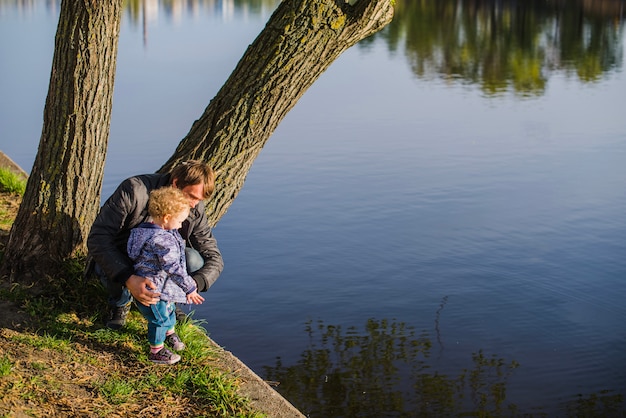 Father with his little son next to the lake