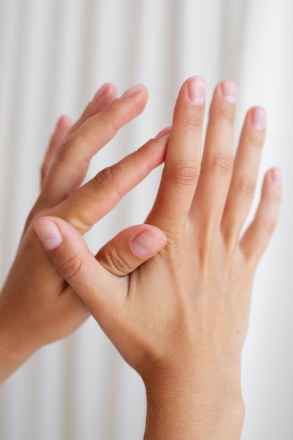 Studio portrait with hands holding each other