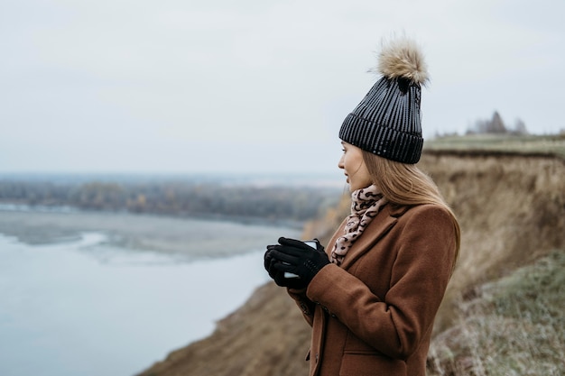 Side view of woman admiring the lake