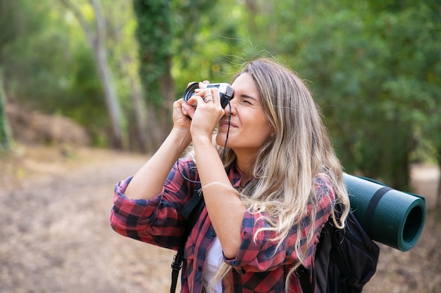 Female Tourist Exploring Nature and Taking Photos