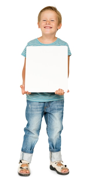 Studio Portrait of Little Boy Holding Blank Paper Board