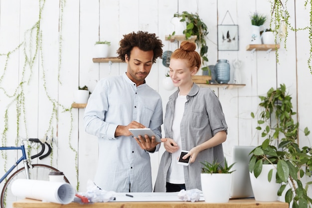 Young Family Couple Making Blueprints of Their Future House