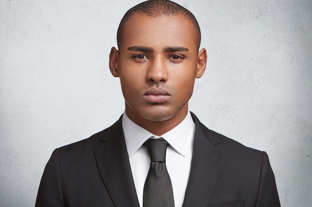 Portrait of expressive young man wearing formal suit