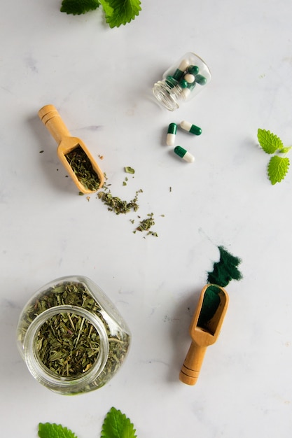 Top View Jar with Herbs and Capsules on the Table