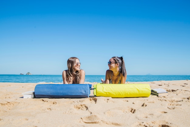 Girl lying at the beach looking at each other