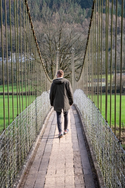 Man Walking Over a Bridge – Free Download Stock Photo