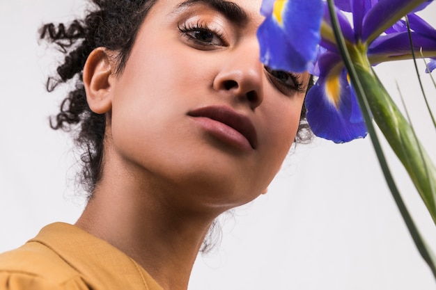 Ethnic woman with bouquet of blue flowers