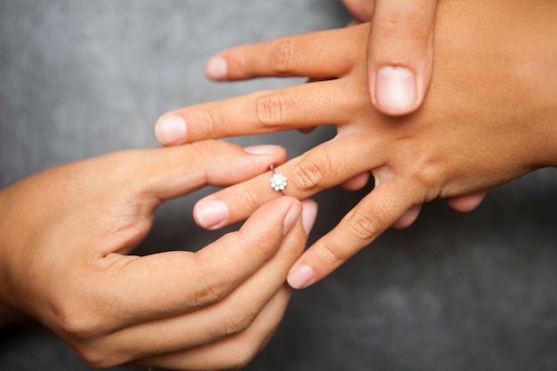 Marriage Proposal Concept: Man Giving Wedding Ring to Woman