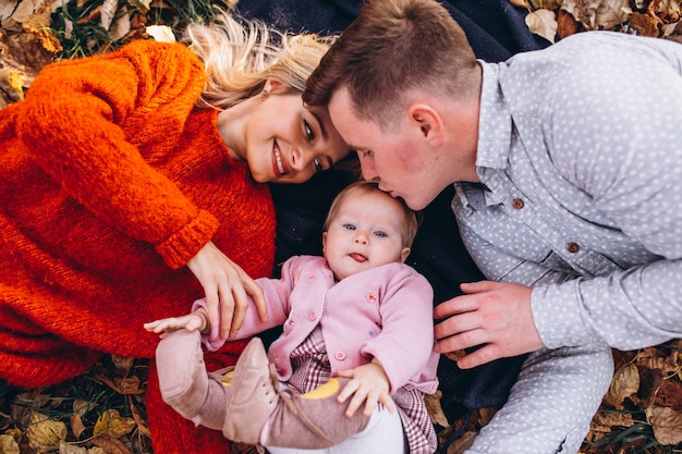 Family with baby daughter enjoying nature in the park