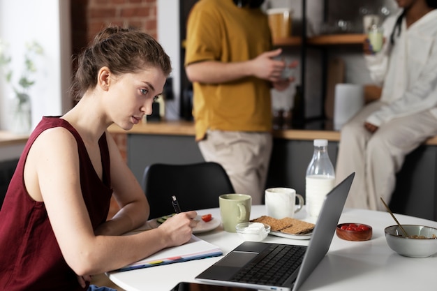 Side view woman working on laptop