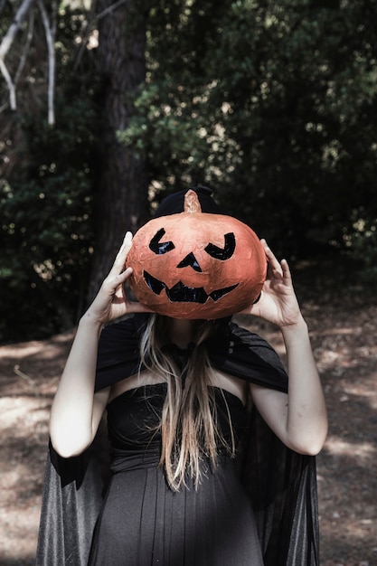 Lady Closing Face by Pumpkin in Park – Free Stock Photo for Download