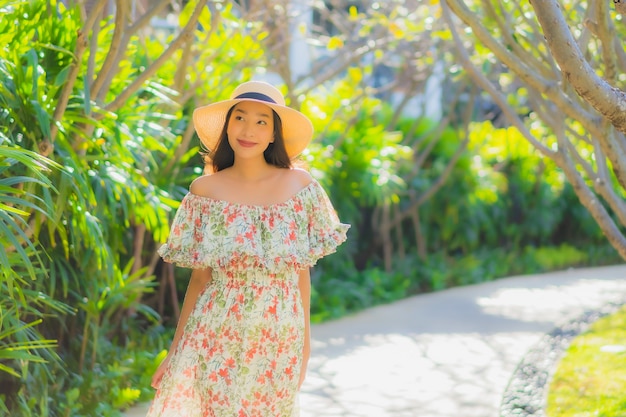 Beautiful Young Asian Woman Walking Happily in an Outdoor Garden