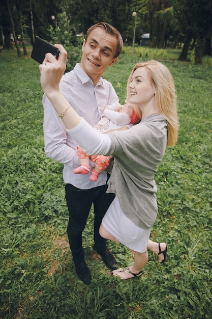 Couple with a baby capturing a moment | Free Stock Photo for Download