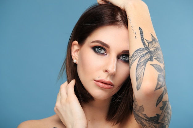 Woman with Blue Eyes and Butterfly Tattoo: Free Stock Photo